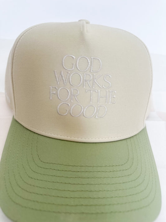 God Works for the Good Trucker Hat